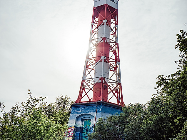 Leuchtturm Wittenbergen in Rot-Weiß vor Himmel und Bäumen am Elbstrand bei Hamburg
