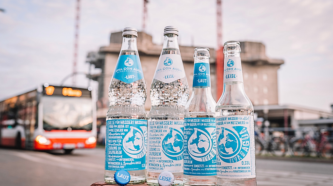 Mineralwasser mit den Beschriftungen laut und leise stehen auf einer Backsteinmauer in Hamburger während im Hintergrund ein Bus leicht verschwommen zu sehen ist