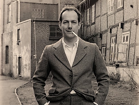 Lässiger Mann vor Backsteingebäuden