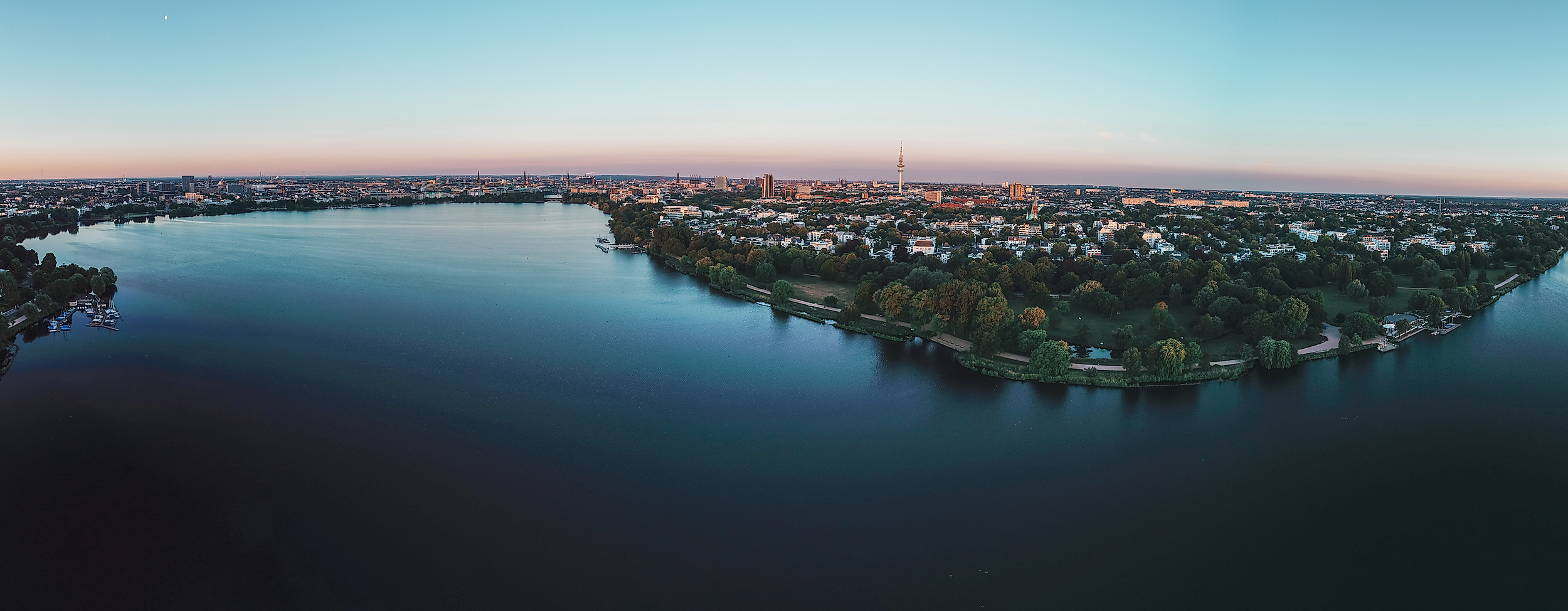 Panorama der beleuchteten Außenalster in der Morgendämmerung mit Blick auf das umliegende Stadtgebiet