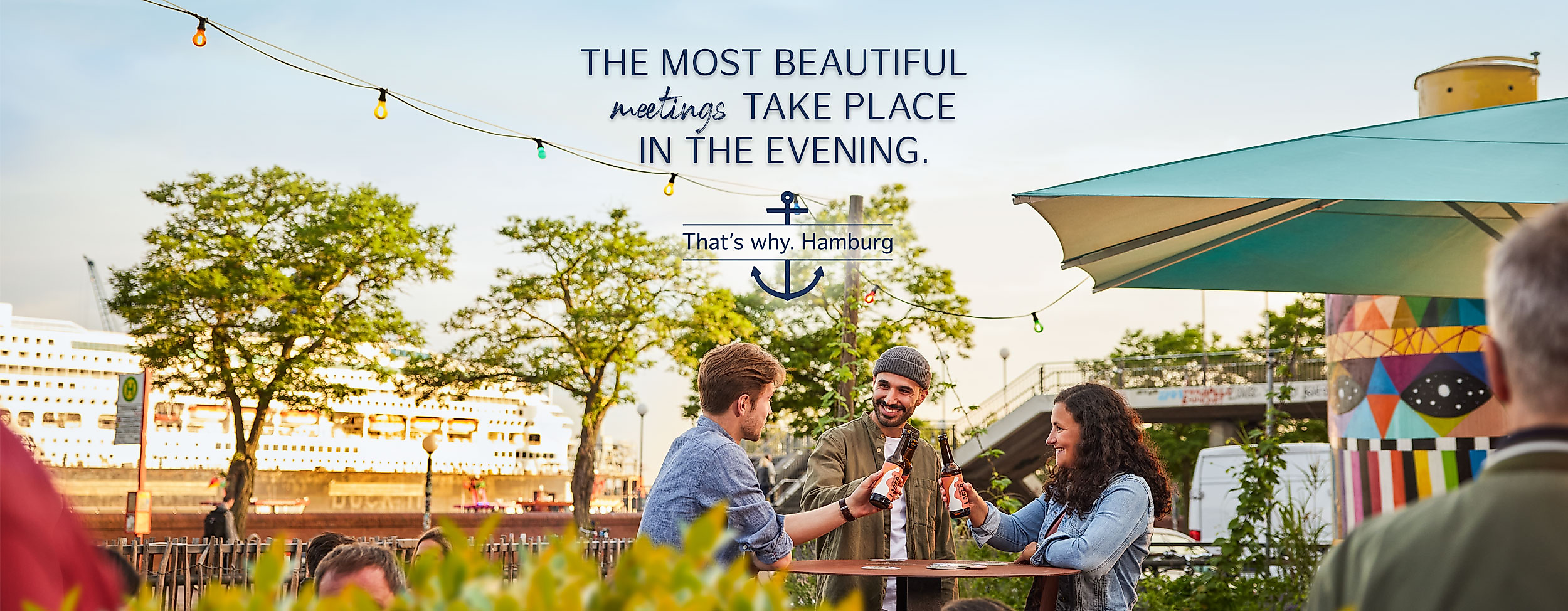Three friends in Hamburg with beer in their hands in summer