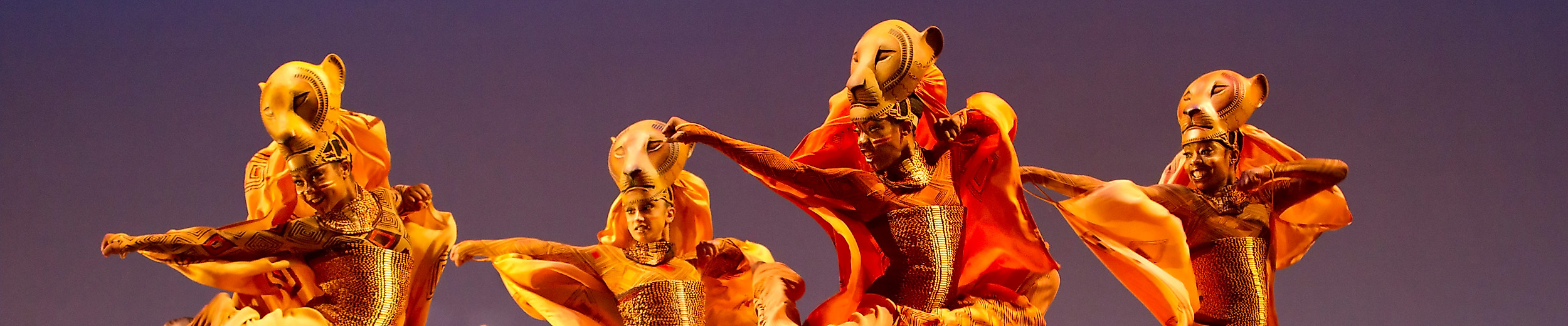 Four people dressed as lionesses on the stage of The Lion King