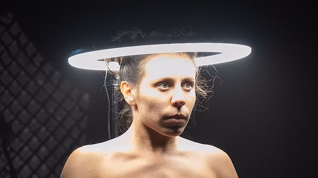 The head of a performer is surrounded by a bright circle of light.