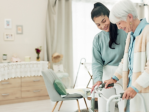 young-woman-helping-senior-with-walker-indoors-2026-09-24-12-49-38-utc