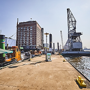 Promenade am Museumshafen Oevelgönne mit historischen Schiffen und Blick auf die Elbe bei Sonnenschein
