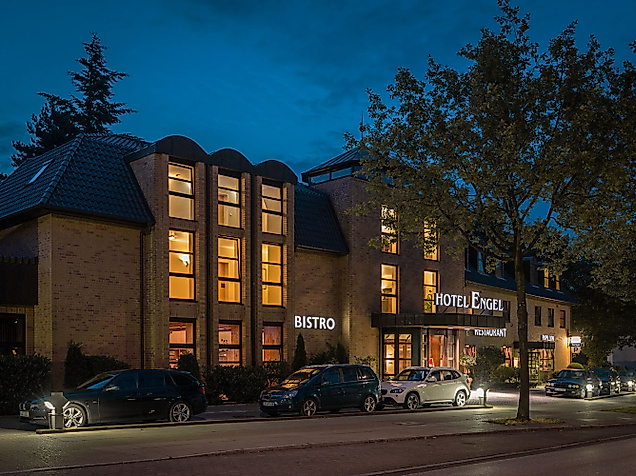 Hotel Engel: Backsteinbau mit leuchtenden Fenstern und den Schriftzügen „Hotel Engel“, „Bistro“ und „Restaurant“ bei Nacht.