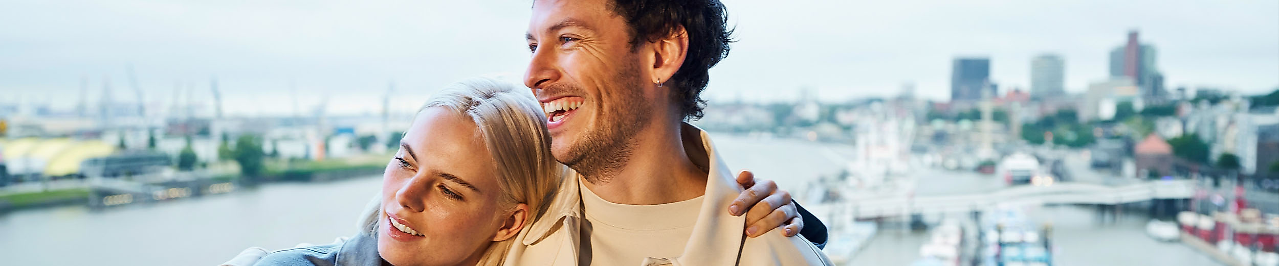 A couple stands arm in arm on the viewing platform of the Elphi.