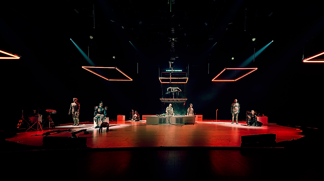 Part of the performance Eternal Dawn, showing performers in robot-like costumes on stage.